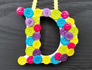 Wooden letter covered with colorful buttons