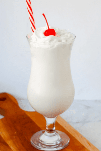 vanilla frappuccino in glass milkshake glass with cherry on top