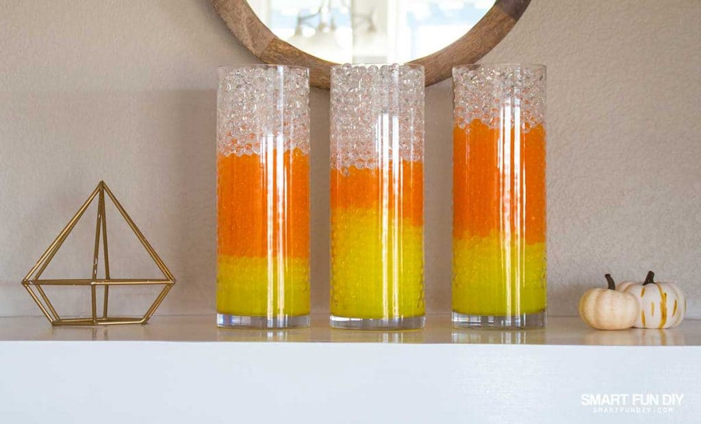 candy corn water beads layered in glass cylinders