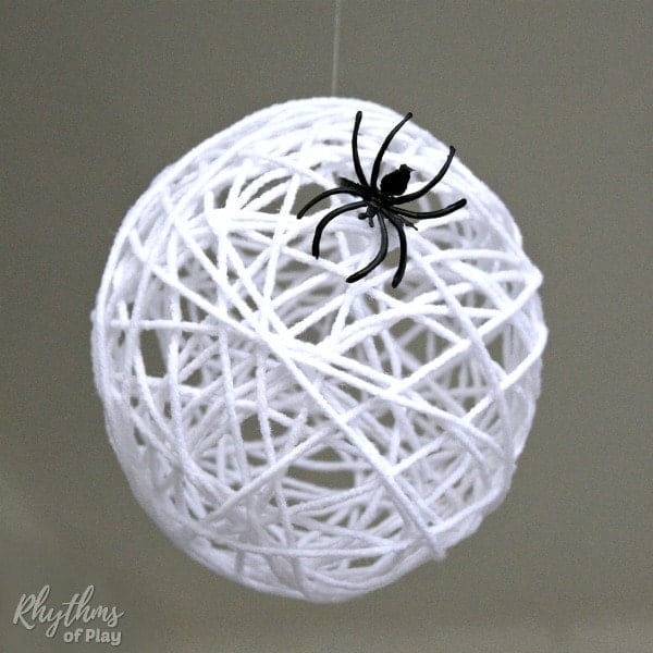 DIY Halloween Decor Idea with handmade spider web egg sack and fake spider