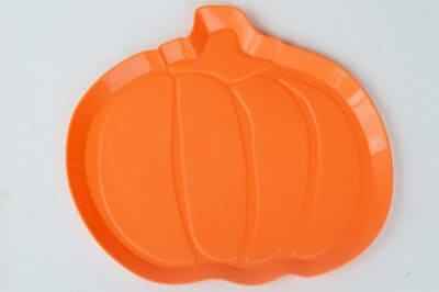 Orange plastic pumpkin shaped tray