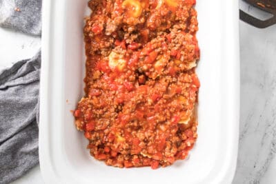 Layering sauce in ravioli lasagna