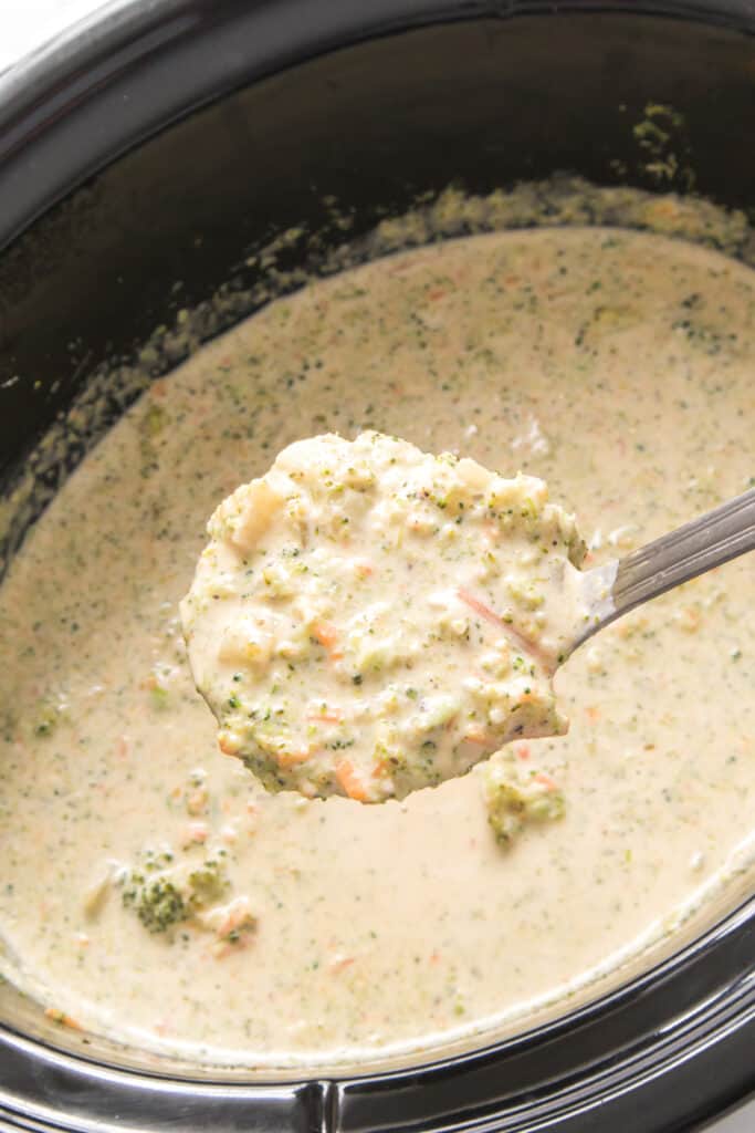 laddle with broccoli cheese soup made in the slow cooker