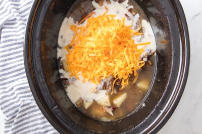 Cheese on top of cheeseburger soup in a slow cooker
