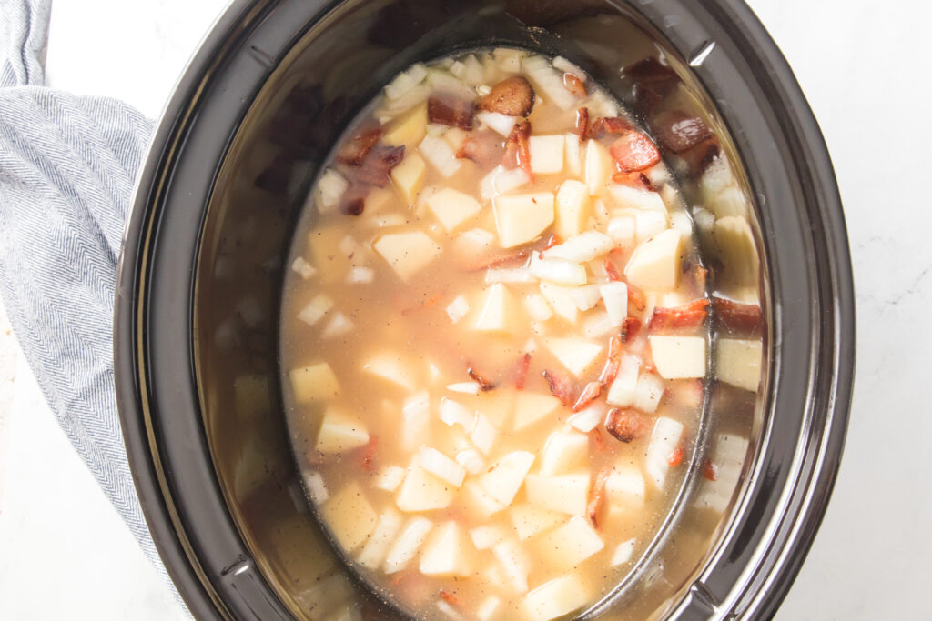 cooked potatoes, onion, bacon, chicken broth, salt and pepper in slow cooker