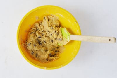 Chocolate chip cookie dough in a yellow bowl