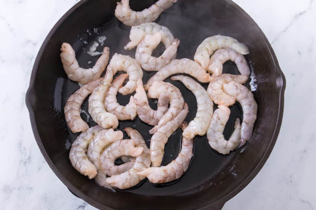 shrimp cooking in cast iron skillet