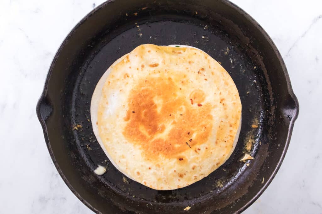 toasted tortilla in cast iron skillet