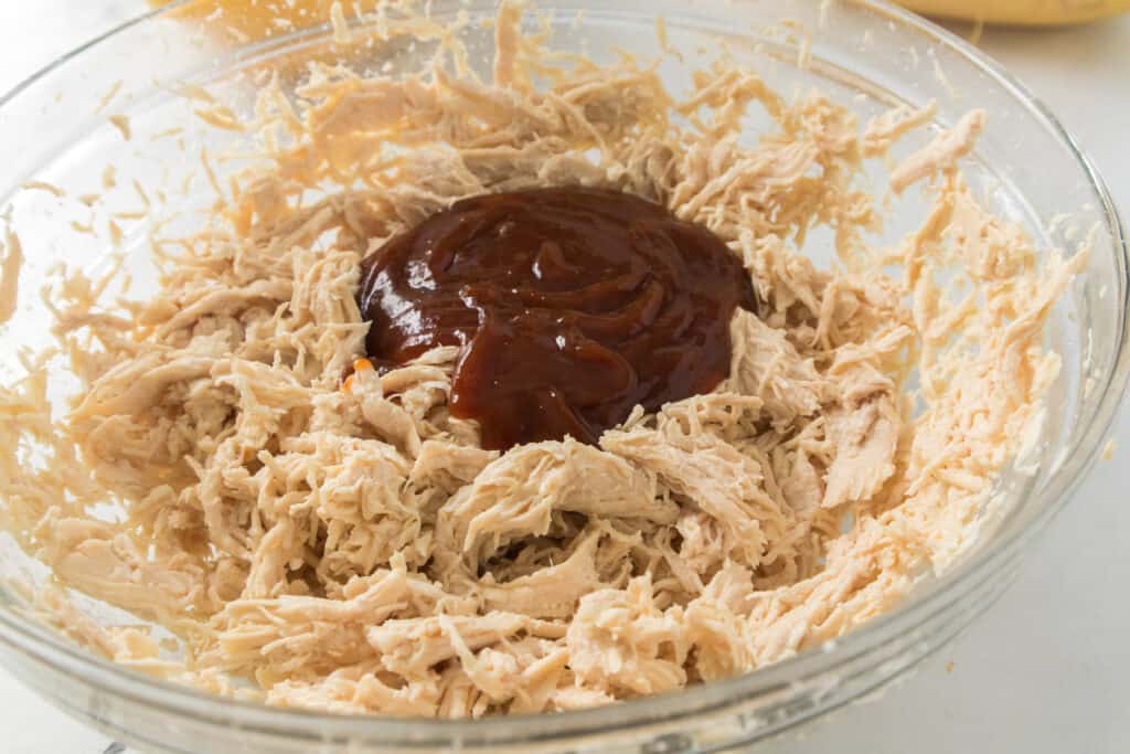 bowl of shredded chicken with bbq sauce