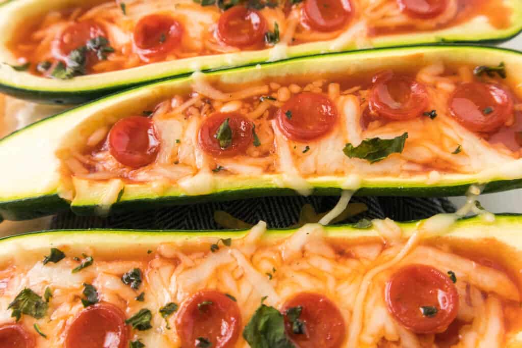 baked pizza zucchini boats in casserole dish