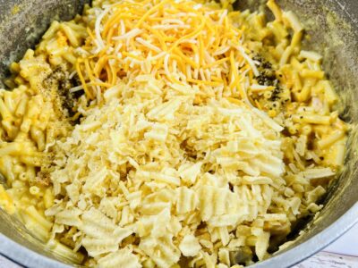 White and yellow cheeses, chips and noodles in a bowl