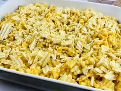 Chips, cheeses, and noodles layered in a baking dish