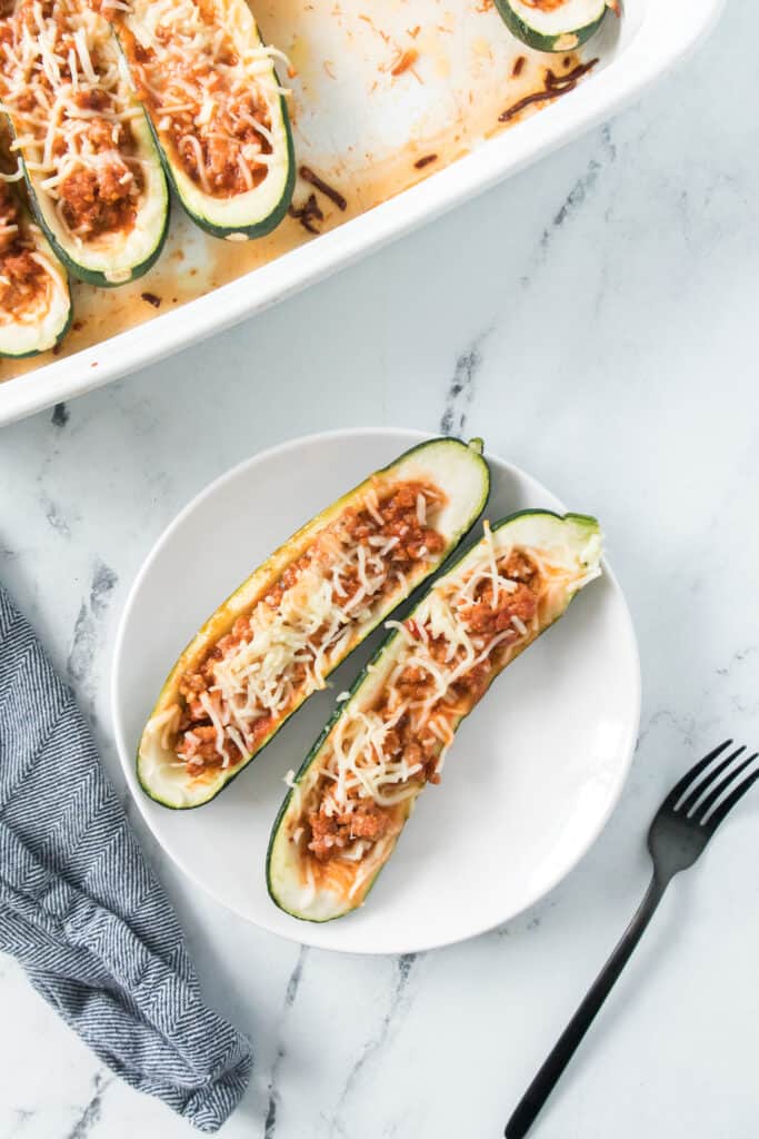 stuffed zucchini boat with ground chicken on plate