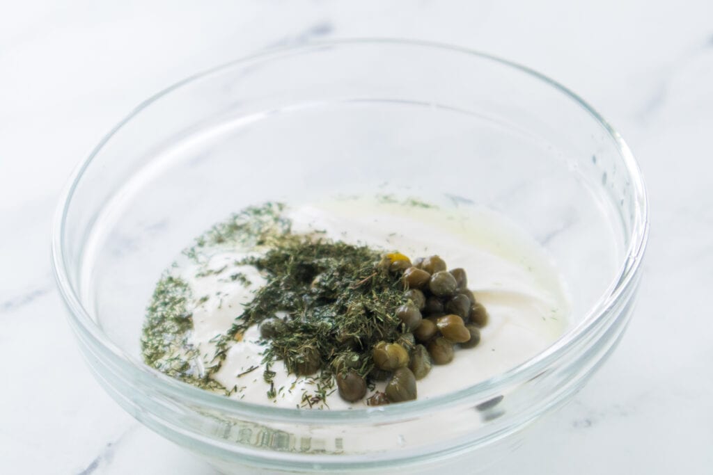 ingredients in glass bowl for dill caper sauce