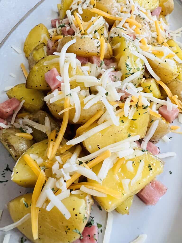 potatoes with ham cubes and shredded cheese